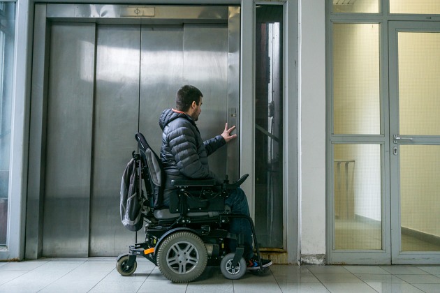 Man in wheelchair at elevator