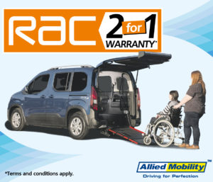 Woman in wheelchair and man next to car ramp