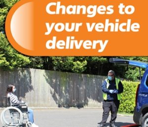Woman in wheelchair and man next to car ramp