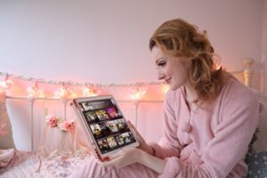 Kate S Woman on bed looking at iPad screen