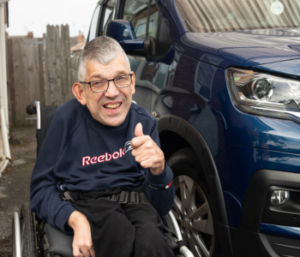 Allied Mobility customer Arlene Hutchinson sits in the second row of Peugeot Horizon in her powerchair.