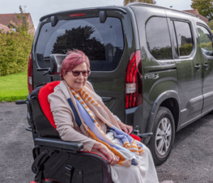 Allied Mobility customer Arlene Hutchinson sits in the second row of Peugeot Horizon in her powerchair.