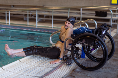 Wheelchair user by a swimming pool