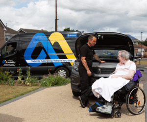 Mobile mechanic, Paul, speaks to Neil, a wheelchair user, by the open bonnet of his WAV.
