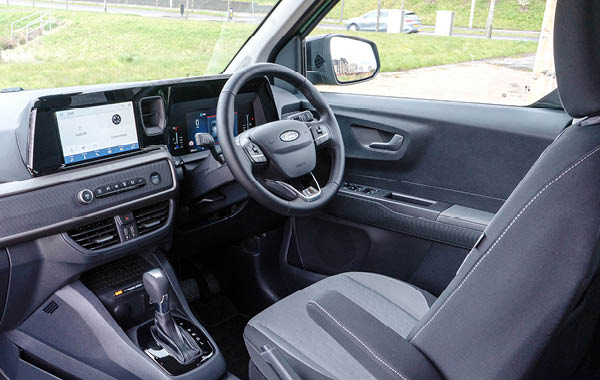 Interior view of the Ford Valeso driver’s seat and dashboard showing the steering wheel, touchscreen display, and front seating.