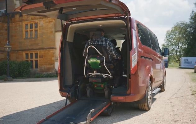Nick Wilson entering his wheelchair accessible vehicle using the built-in rear wheelchair ramp.