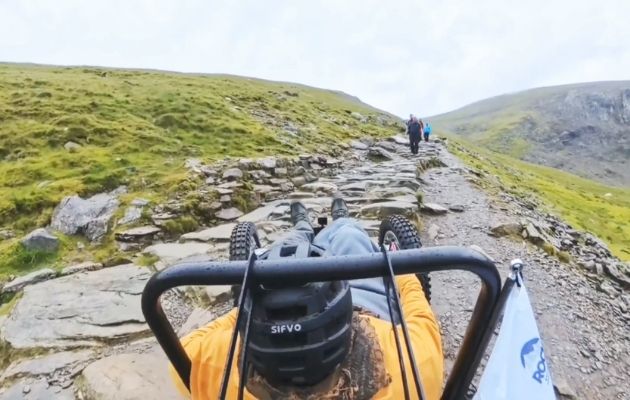 Nick in his all-terrain wheelchair on a rocky path on Snowdon (Yr Wyddfa).